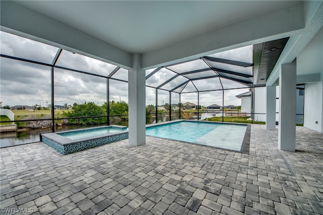 view of swimming pool with a patio, an in ground hot tub, and glass enclosure