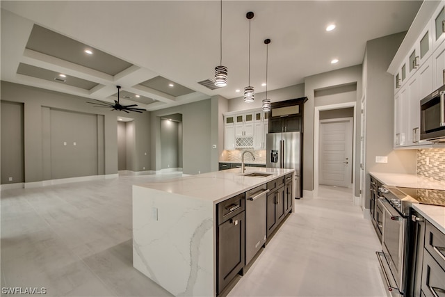 kitchen with white cabinets, coffered ceiling, tasteful backsplash, and ceiling fan