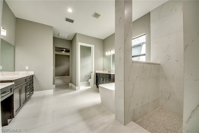 bathroom featuring vanity, tile flooring, and a tub