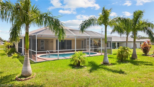 back of house with a yard and a lanai