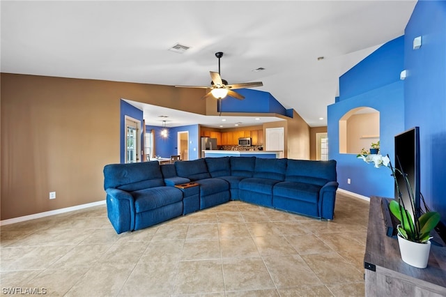 living room featuring ceiling fan, lofted ceiling, and light tile patterned flooring