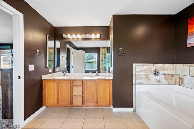 bathroom featuring tile patterned flooring, vanity, and a washtub