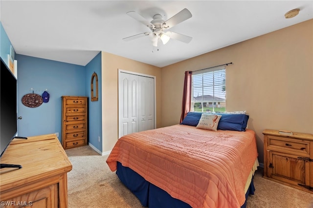 carpeted bedroom with ceiling fan and a closet