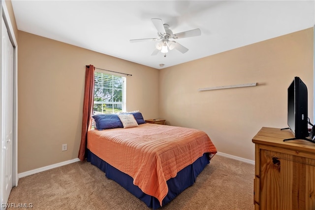 bedroom with light colored carpet, a closet, and ceiling fan