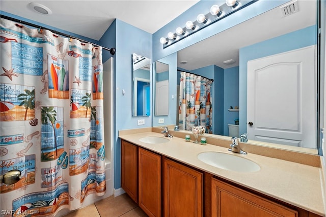 bathroom with tile patterned flooring, vanity, and shower / bath combo