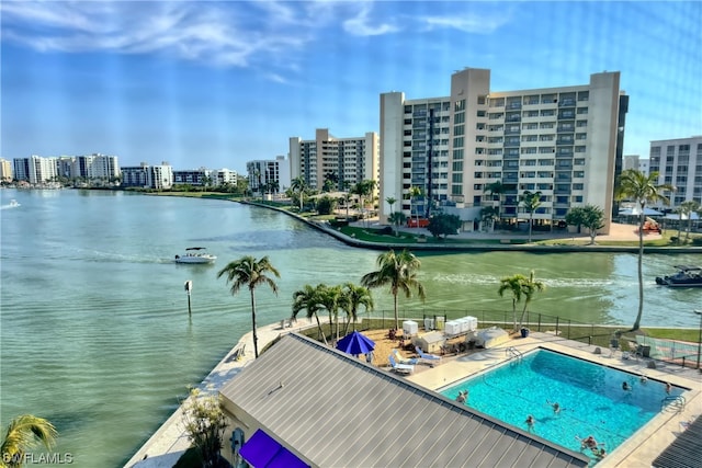 view of swimming pool with a water view