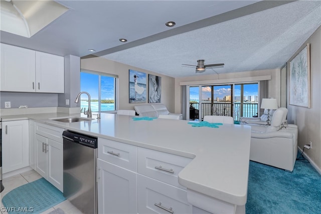 kitchen featuring light tile floors, ceiling fan, a textured ceiling, dishwasher, and sink