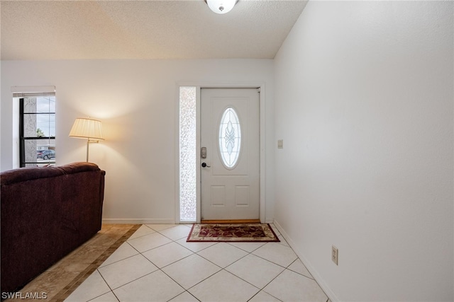 tiled entrance foyer featuring a textured ceiling