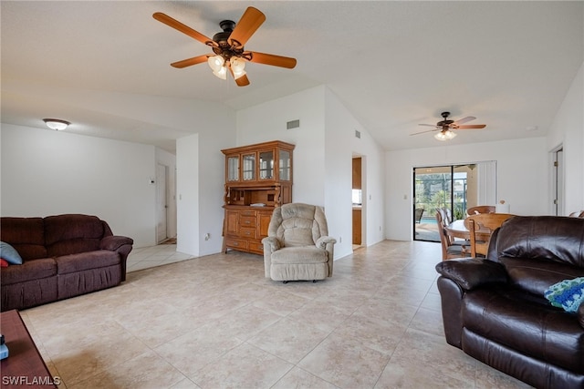 living room with ceiling fan, light tile patterned flooring, and lofted ceiling