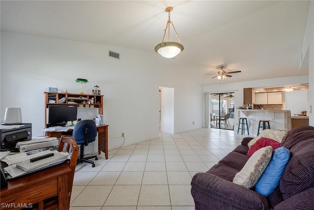 home office with ceiling fan, light tile patterned floors, and vaulted ceiling