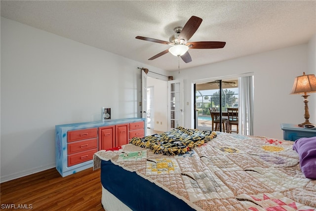 bedroom with a textured ceiling, access to exterior, ceiling fan, and dark hardwood / wood-style floors