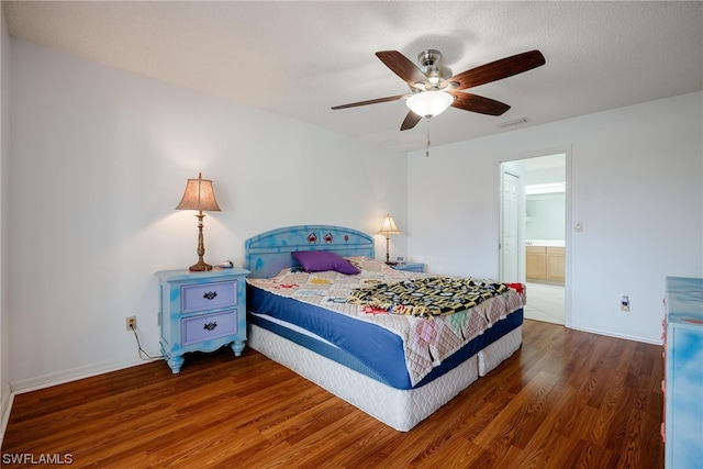 bedroom with a textured ceiling, ceiling fan, and dark wood-type flooring