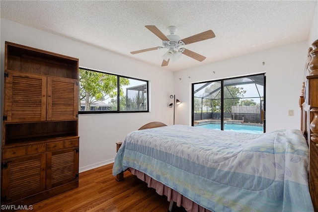 bedroom with multiple windows, a textured ceiling, access to outside, and ceiling fan