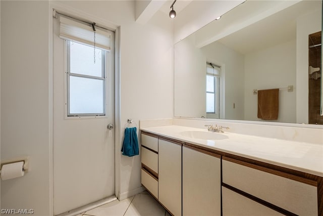 bathroom with tile patterned flooring and vanity