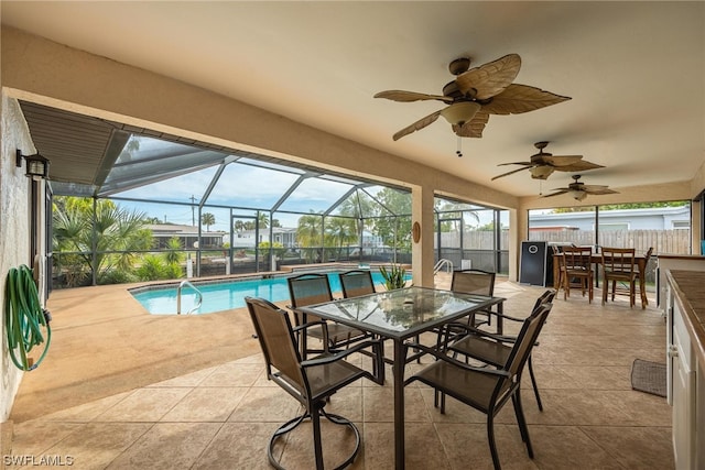 sunroom / solarium featuring a wealth of natural light, ceiling fan, and a swimming pool