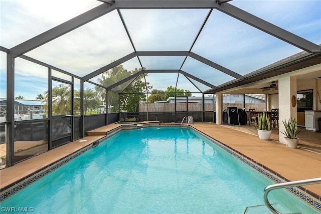 view of pool featuring glass enclosure and a patio