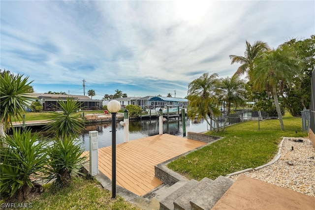 dock area featuring a water view and a lawn