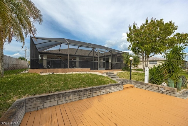 wooden deck featuring a yard and glass enclosure