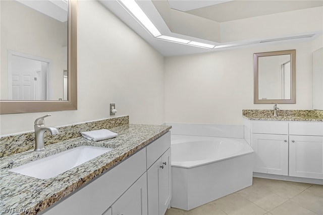 bathroom with vanity, tile patterned floors, and a tub