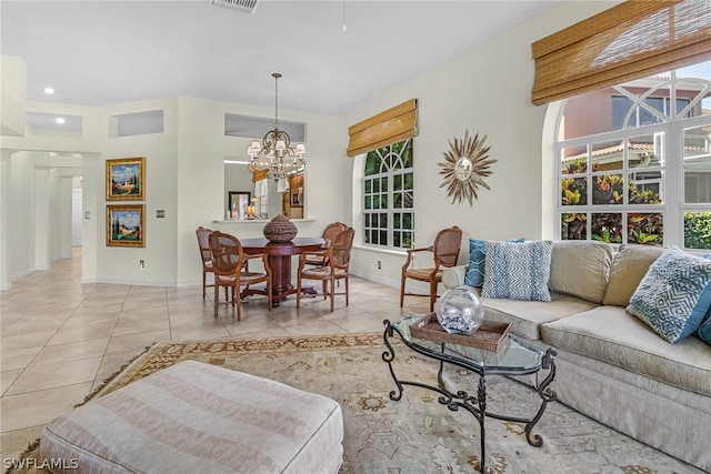 living room with light tile patterned flooring and a notable chandelier