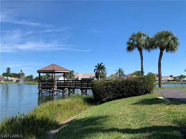 dock area featuring a yard, a water view, and a gazebo