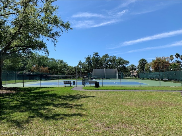 view of sport court with a yard