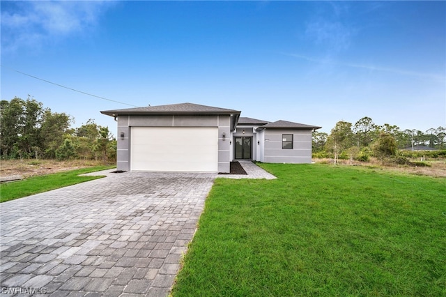 view of front of house with a front lawn and a garage