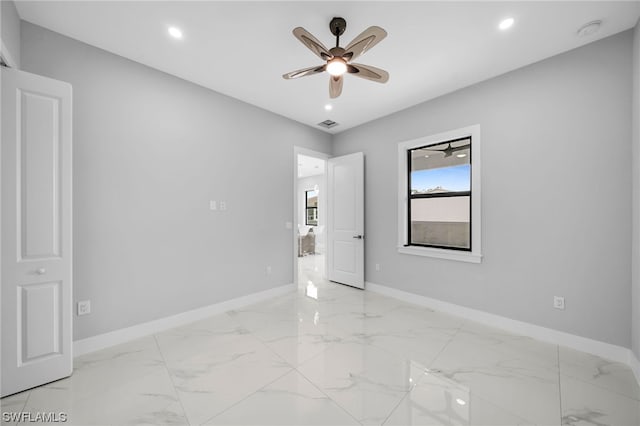 empty room with light tile floors and ceiling fan