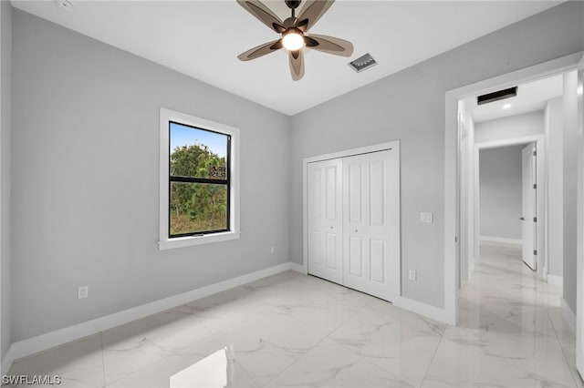 unfurnished bedroom with ceiling fan, a closet, and light tile floors