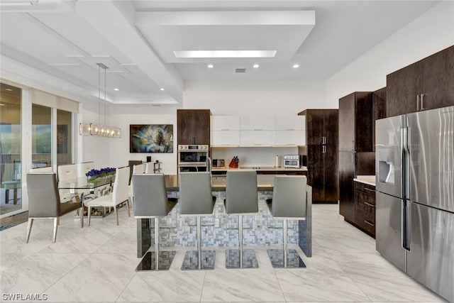 dining room featuring a towering ceiling and a chandelier