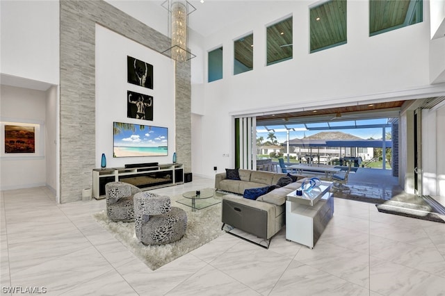 living room featuring a towering ceiling and a chandelier