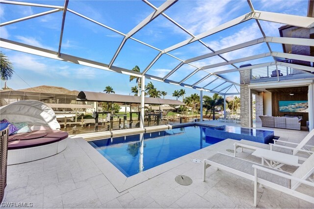 view of pool featuring a water view, a patio, a lanai, and a jacuzzi