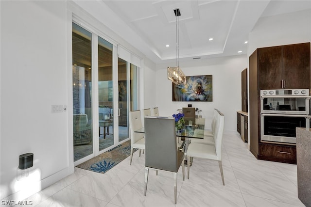 dining space with a raised ceiling