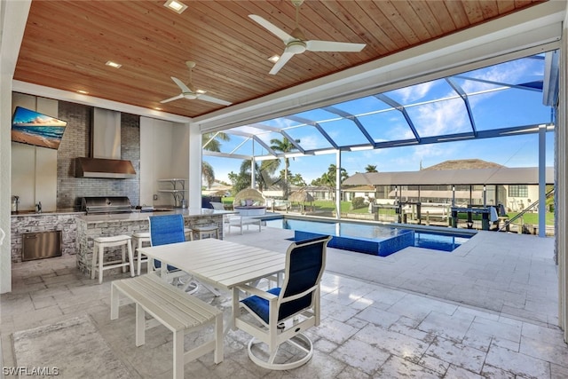 view of patio / terrace with a sink, area for grilling, a grill, and an outdoor pool