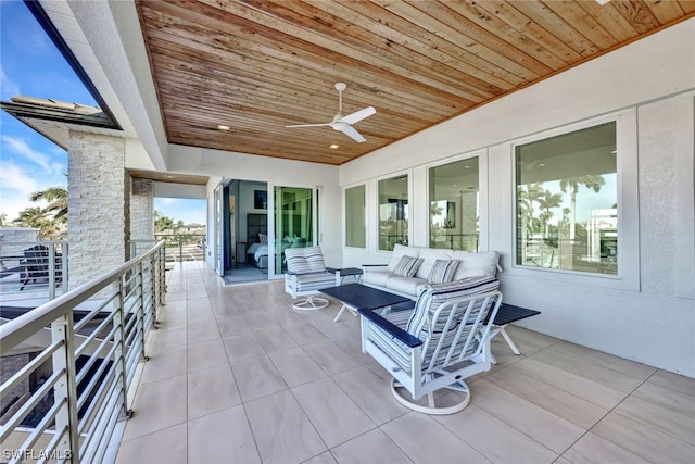 view of patio with an outdoor living space, a balcony, and ceiling fan