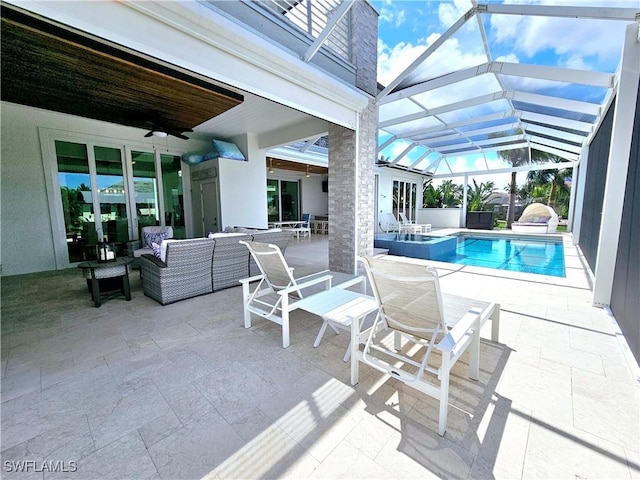 view of pool featuring ceiling fan, an outdoor living space, a patio area, and glass enclosure