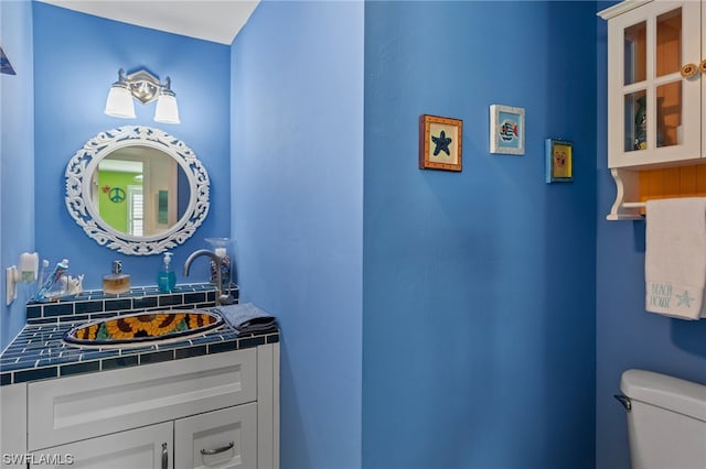 bathroom with toilet and vanity