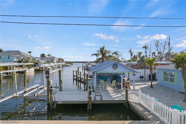 view of dock with a water view and a patio area