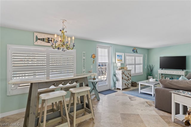 dining area with a notable chandelier and light tile flooring