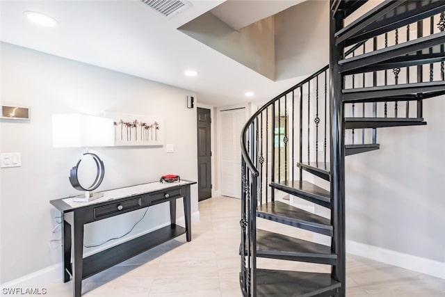 staircase with light tile floors