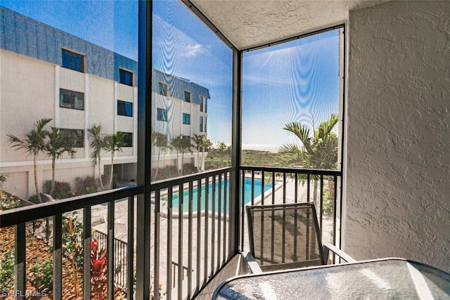 balcony featuring a community pool