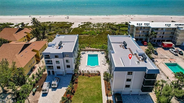 drone / aerial view featuring a water view and a beach view