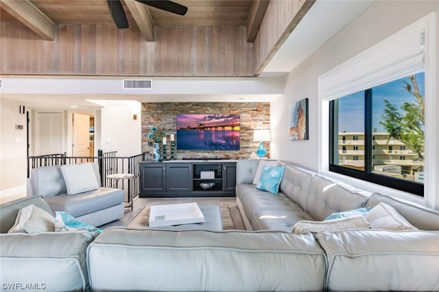 living room featuring ceiling fan, wood ceiling, and beamed ceiling