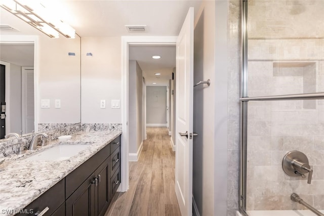 bathroom with oversized vanity and wood-type flooring