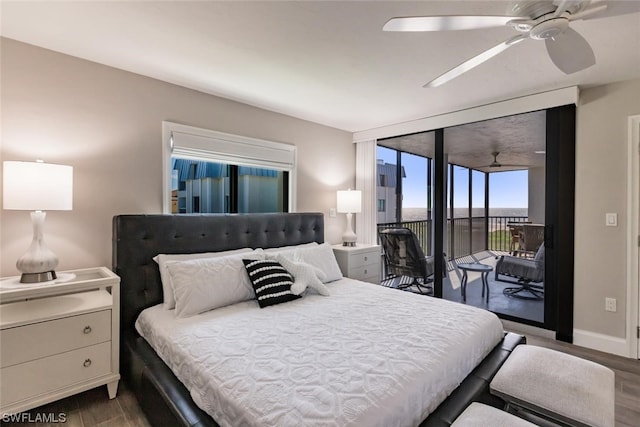 bedroom featuring a wall of windows, access to exterior, ceiling fan, and dark hardwood / wood-style flooring