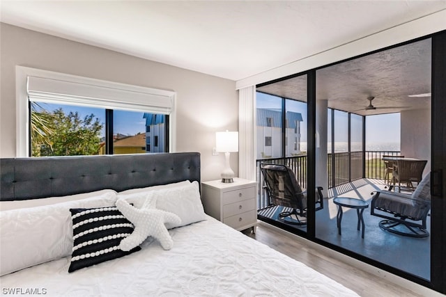 bedroom featuring access to outside and light wood-type flooring