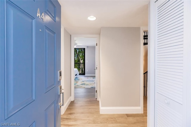 hallway with light hardwood / wood-style floors