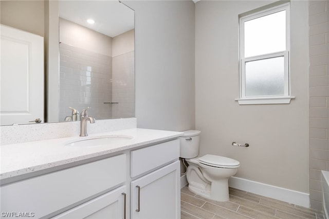 bathroom featuring vanity, tile flooring, and toilet