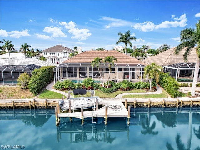 rear view of property featuring a water view and a lanai