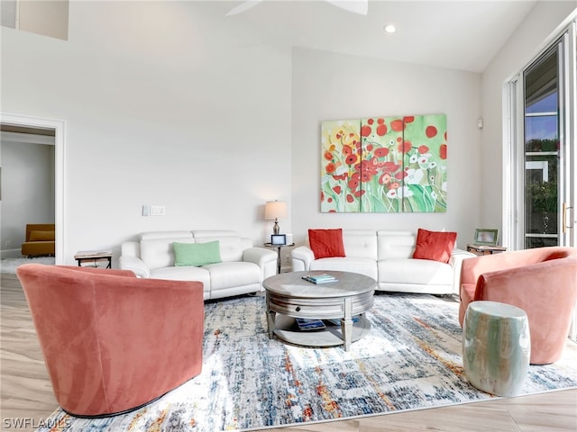 living room featuring light hardwood / wood-style flooring and lofted ceiling